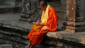 Buddhist Monk writing at Angkor Thom, Cambodia
